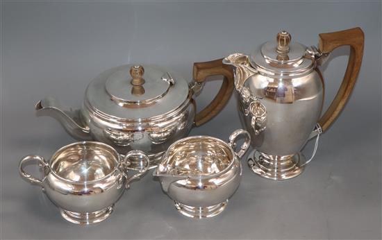 A George VI silver four piece tea set, by C. Eldridge, London, 1940 and a pair of silver sugar tongs, gross 49 oz.